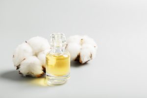 perfume and cotton on a gray background.