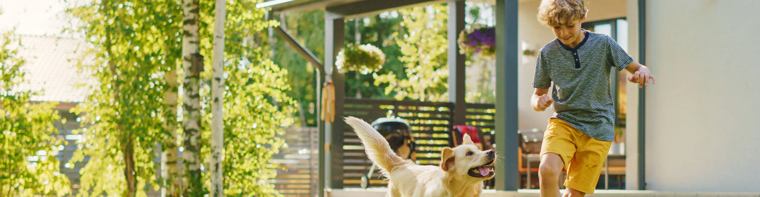 Boy playing with dog in the backyard | Active Pest Control serving Georgia