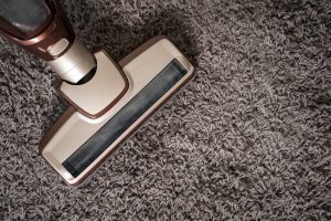 Image of a vacuum running over a carpet