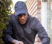 Exterminator inspecting the outside perimeter of a house | Active Pest Control serving Calhoun, GA