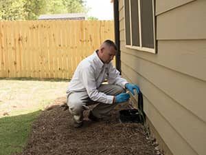 Active Pest Control's tech installing rodent traps to keep rodents out of your home in Georgia