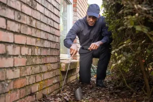 Active Pest Control technician inspecting the exterior of a residential home in Georgia